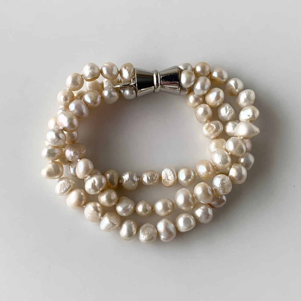 
                      
                        Champagne Baroque 8-9mm Freshwater Knotted Pearls on 8” Long 3-Strand Bracelet with Magnetic Clasp for Easy Wear.
                      
                    