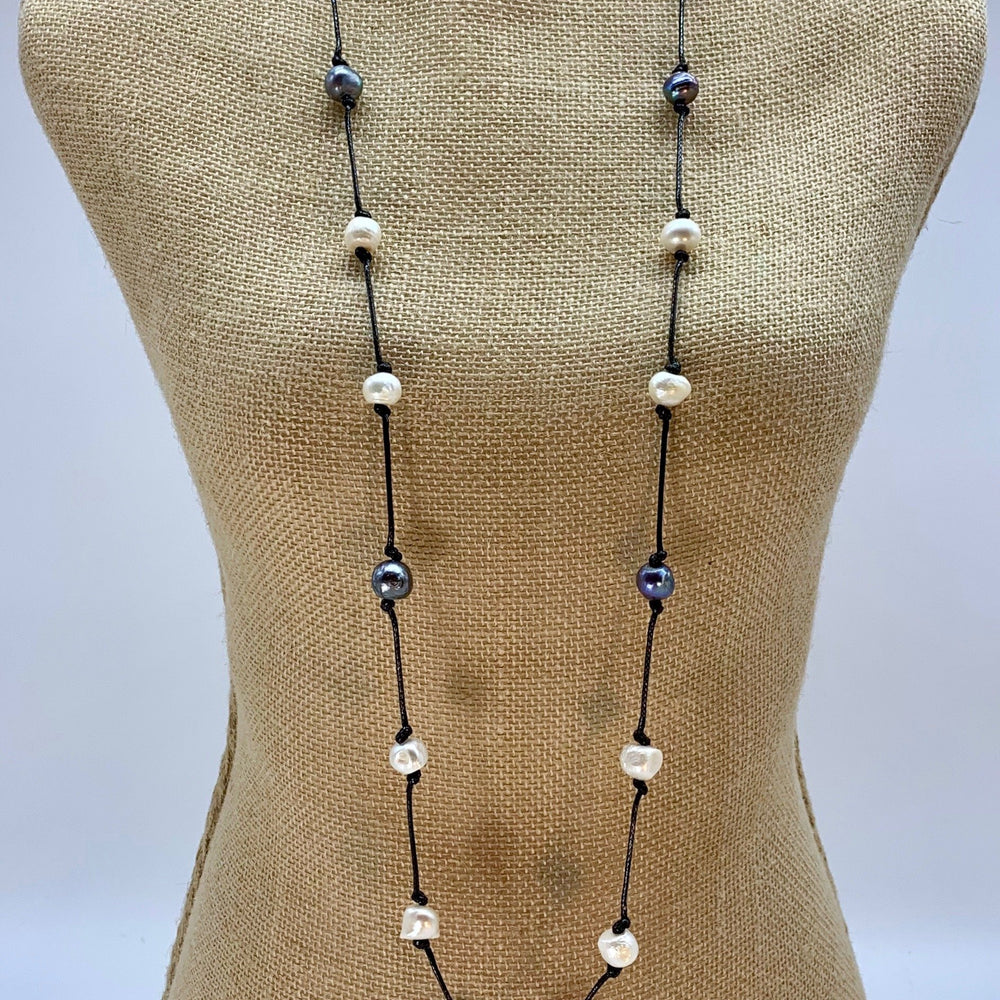 
                      
                        Lustrous White and Silver Freshwater Pearls Knotted on Blue Cotton in this 21” Necklace. On Bust
                      
                    